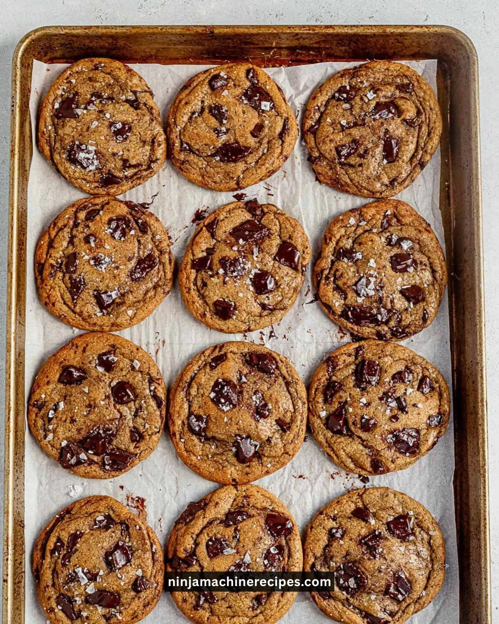 Freshly baked brown butter chocolate chip cookies on a cooling rack.