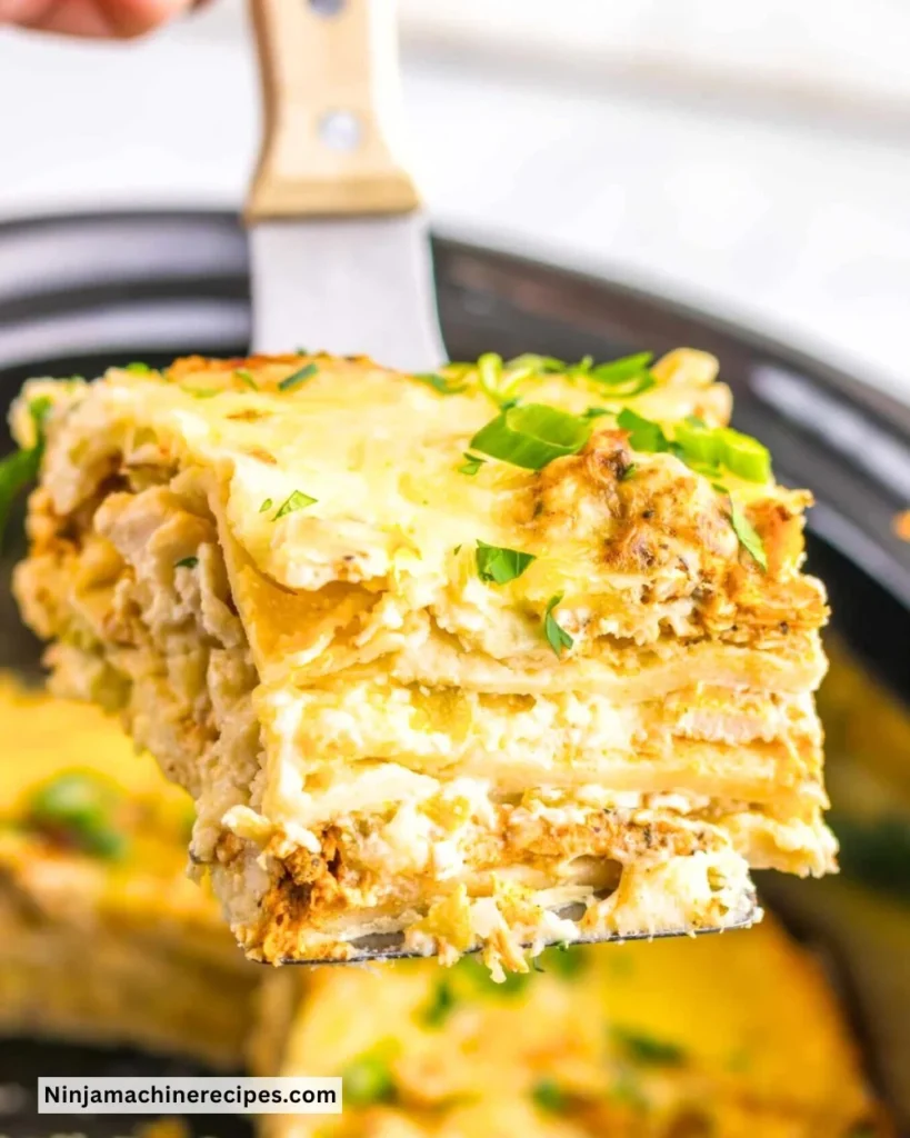 Creamy chicken enchilada casserole cooked in a crockpot with vibrant toppings