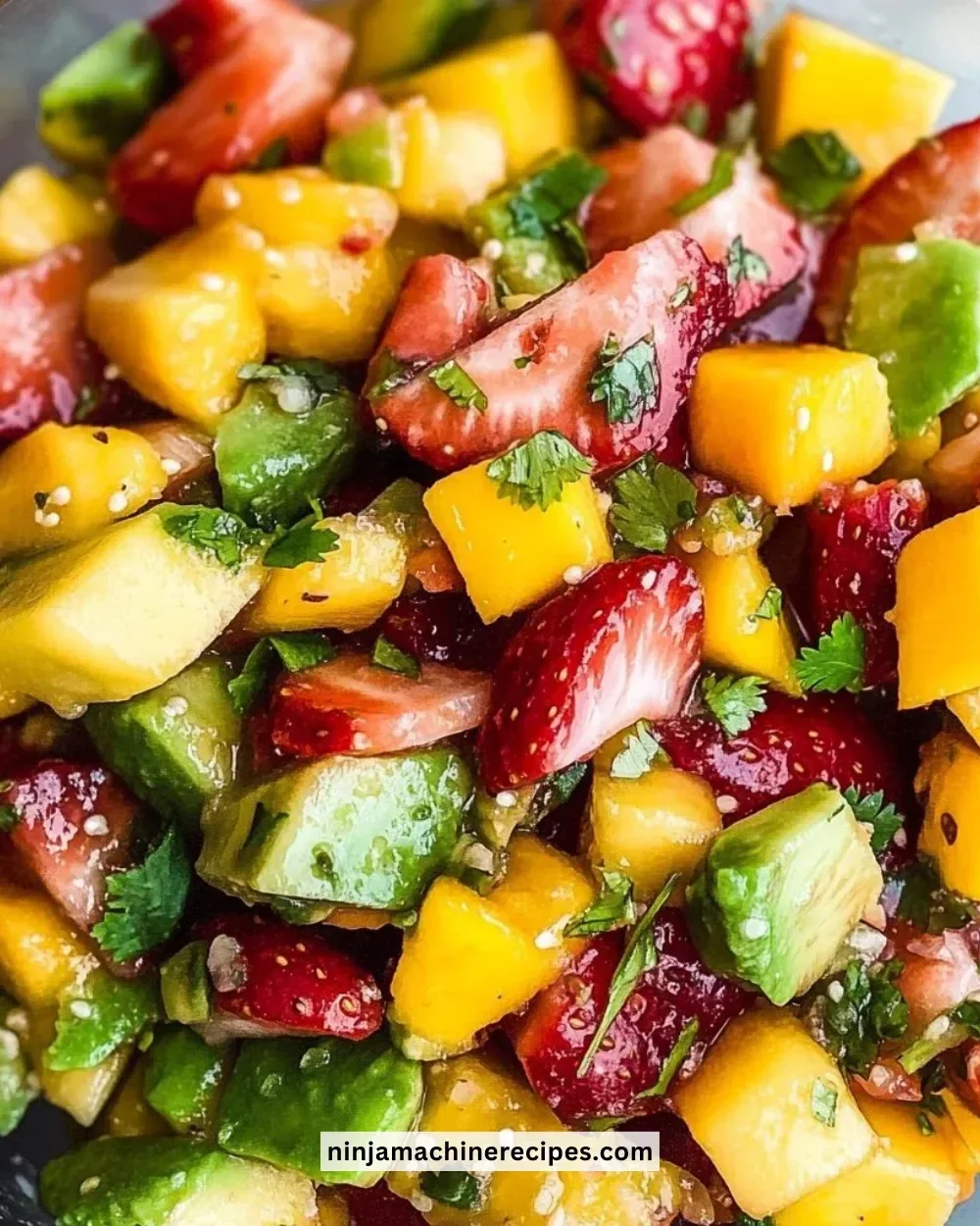 Delicious Avocado Strawberry Mango Salsa served in a bowl with fresh ingredients.
