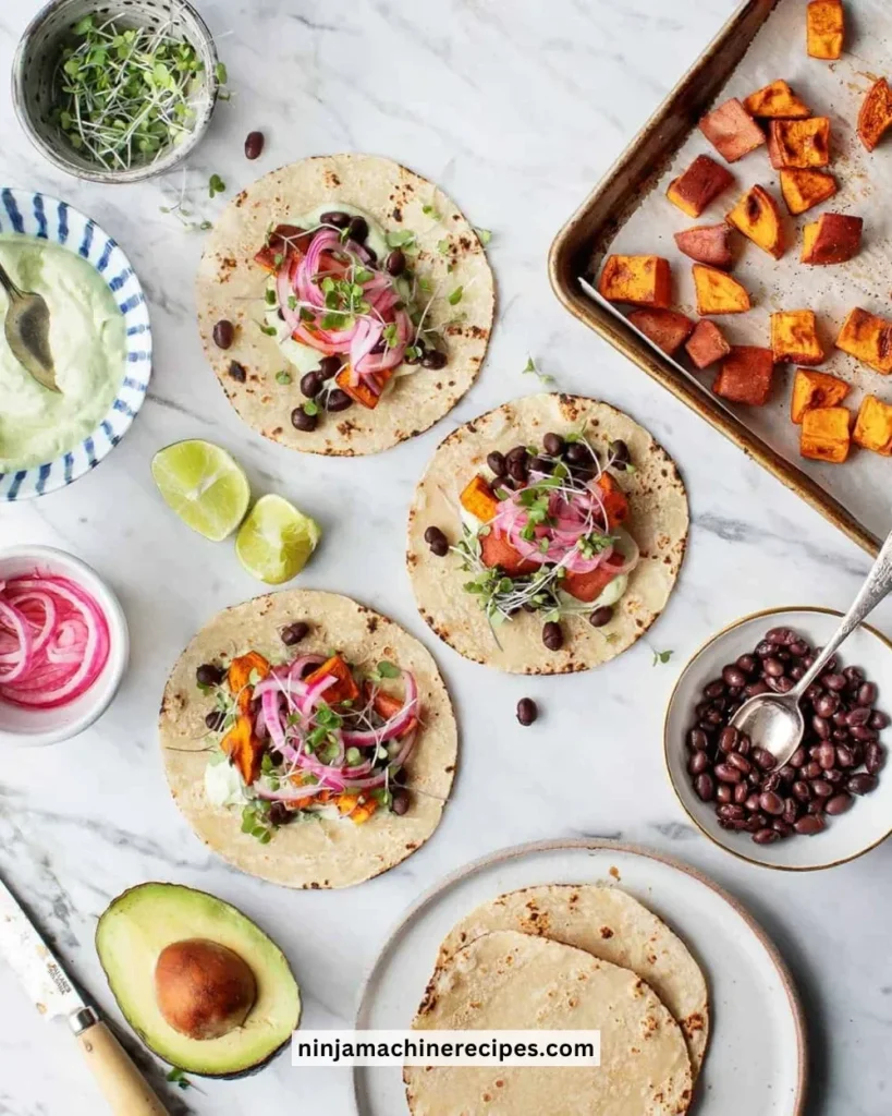 Avocado tacos with sweet potato filling, garnished with fresh toppings