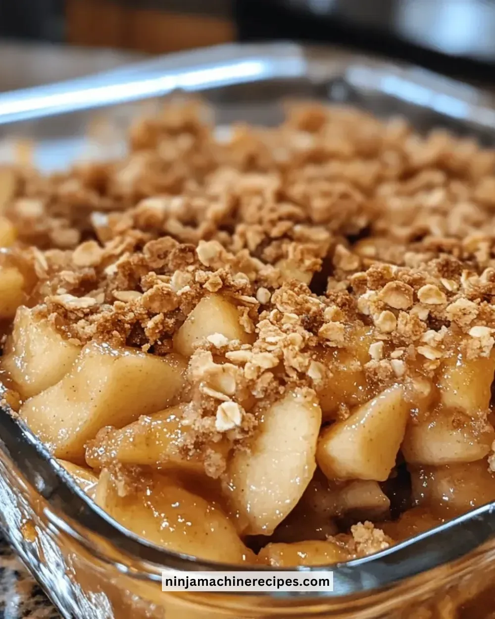 Delicious baked apple crisp with a golden topping and fresh apple slices.