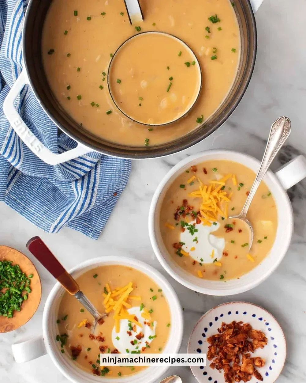 Creamy potato soup garnished with herbs in a rustic bowl