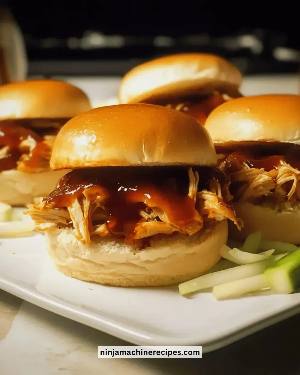 Delicious homemade BBQ chicken sliders topped with coleslaw on a rustic plate.