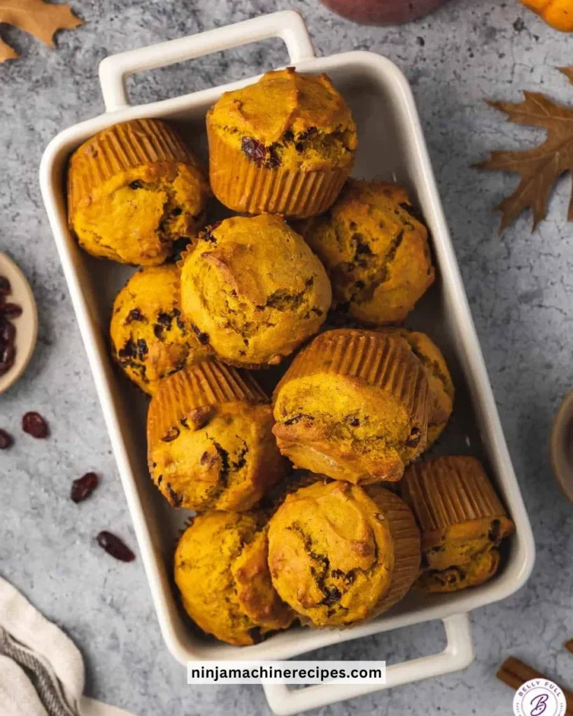 Freshly baked easy cranberry pumpkin muffins on a plate