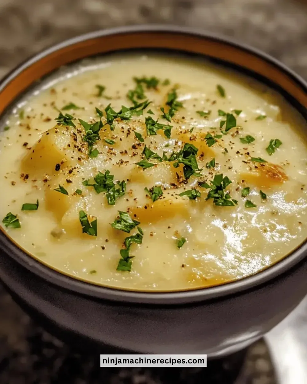 Creamy Instant Pot potato soup garnished with herbs in a bowl