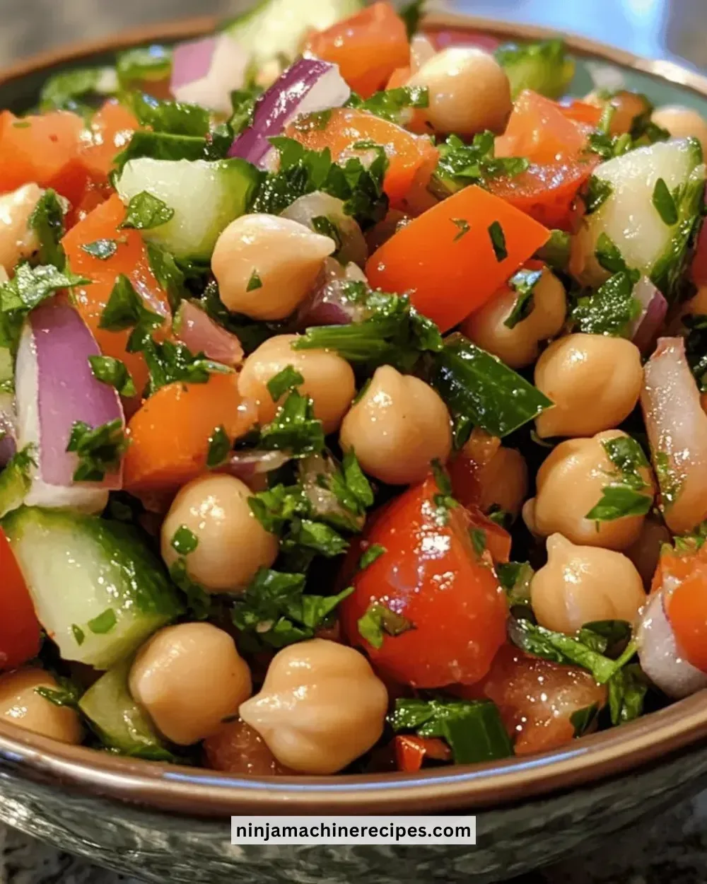 Bowl of easy Mediterranean chickpea salad with fresh vegetables and herbs