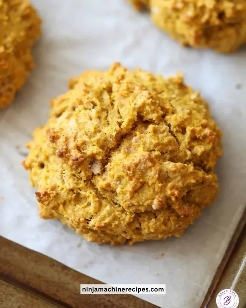 Freshly baked easy pumpkin drop biscuits on a cooling rack