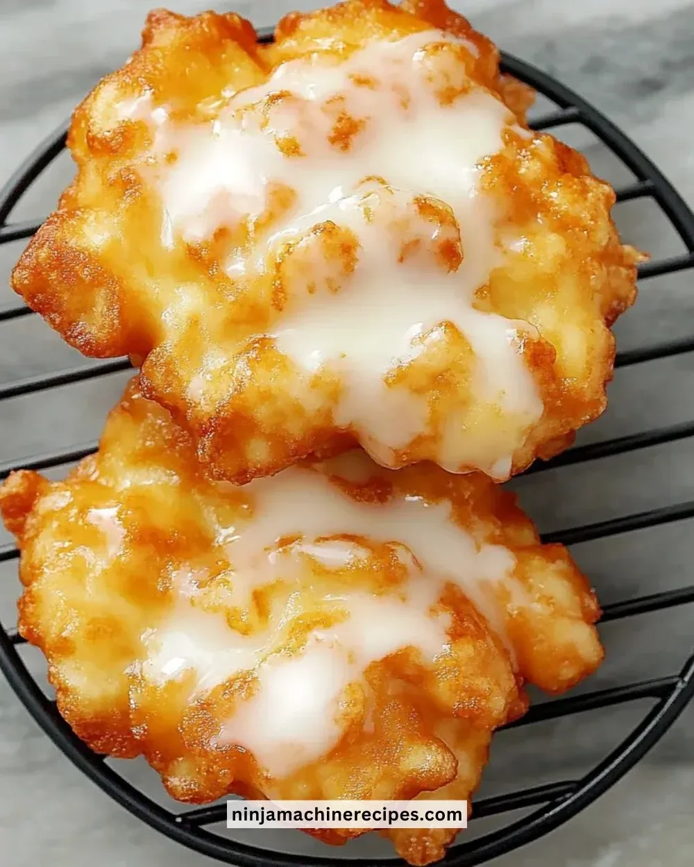 Fresh peach fritters on a plate, golden brown and delicious.