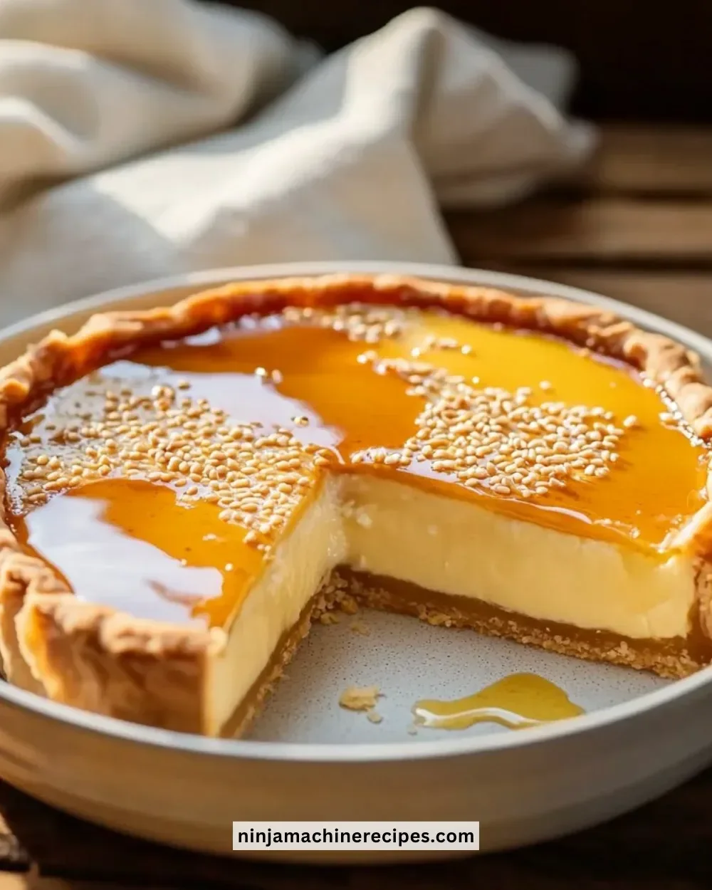 Slice of Golden Greek Honey Pie topped with nuts and drizzled with honey