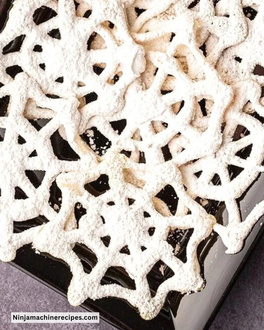 Plate of Halloween Cobweb Cookies decorated with spooky icing