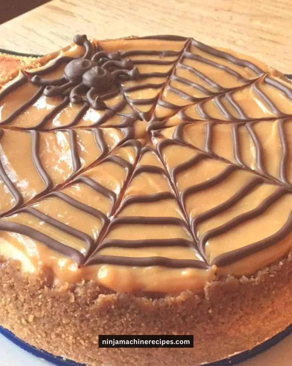 Halloween Spider Web Cheesecake decorated with chocolate and cream, perfect for spooky celebrations.