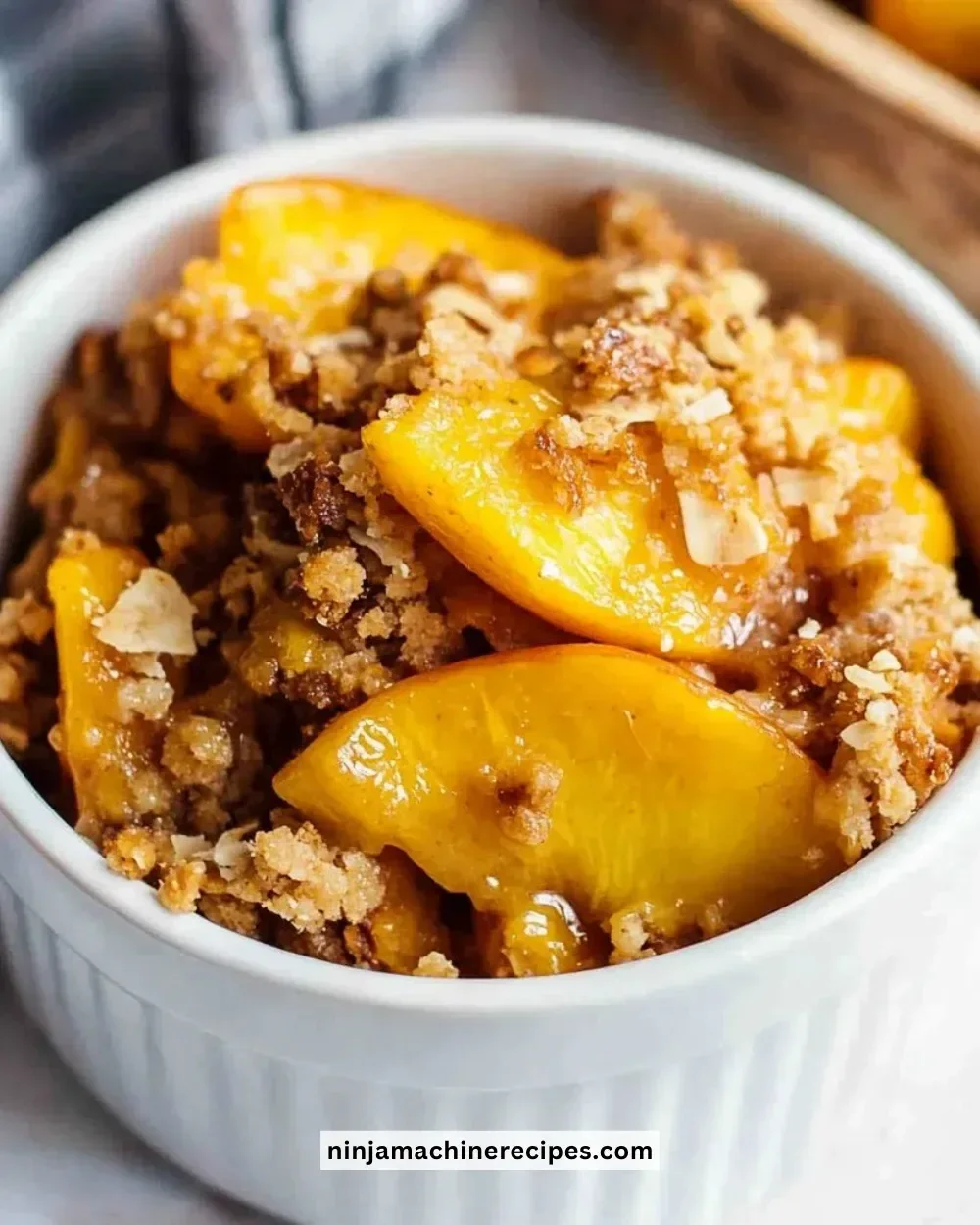 Healthy peach crumble dessert with fresh peaches and a crunchy topping.