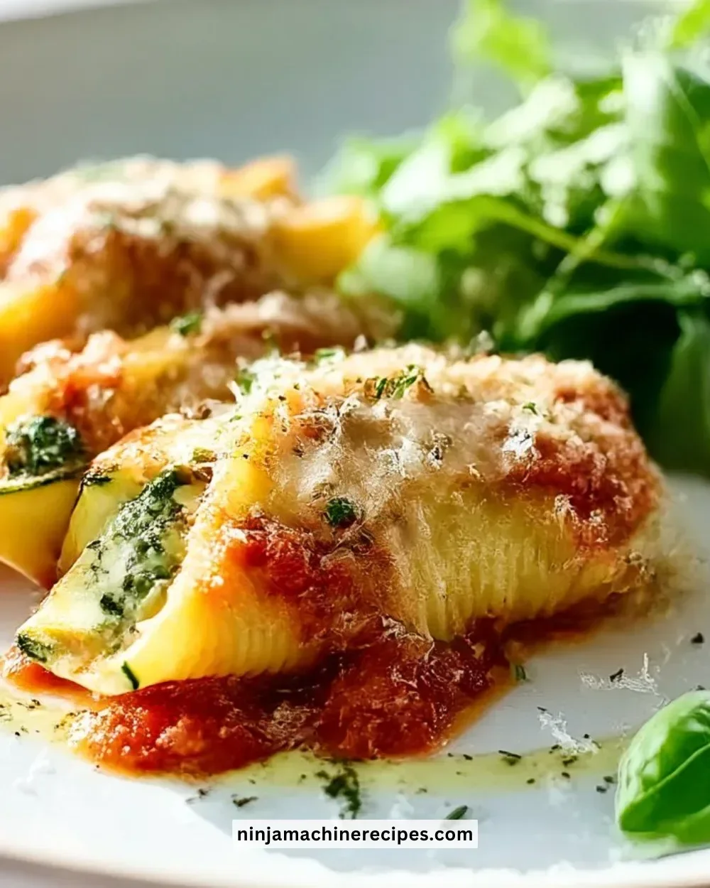 Plate of Herb and Zucchini Stuffed Jumbo Shells garnished with fresh herbs