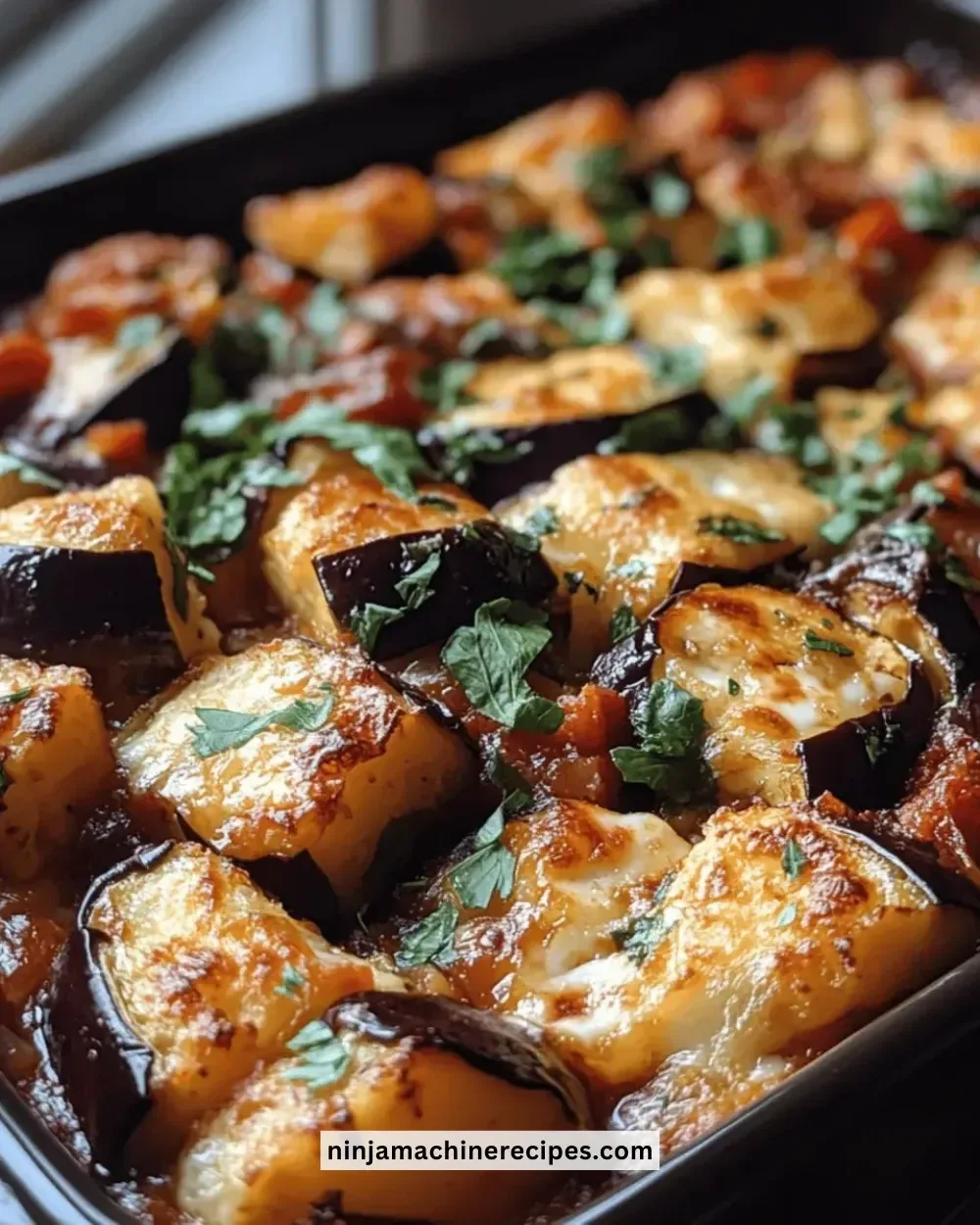 Delicious eggplant and halloumi bake served in a ceramic dish