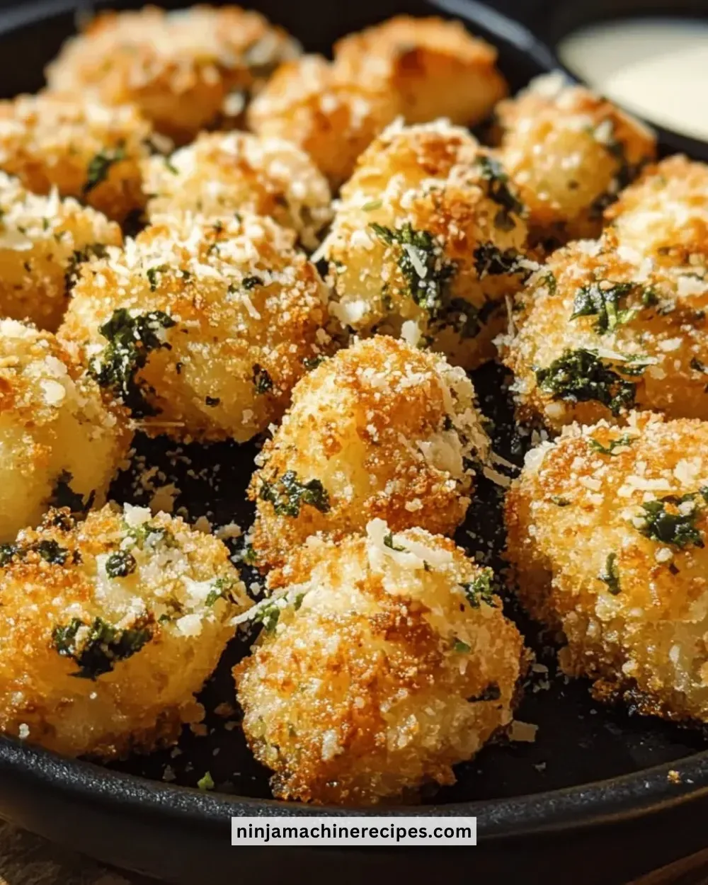 Plate of crispy garlic parmesan bites garnished with parsley