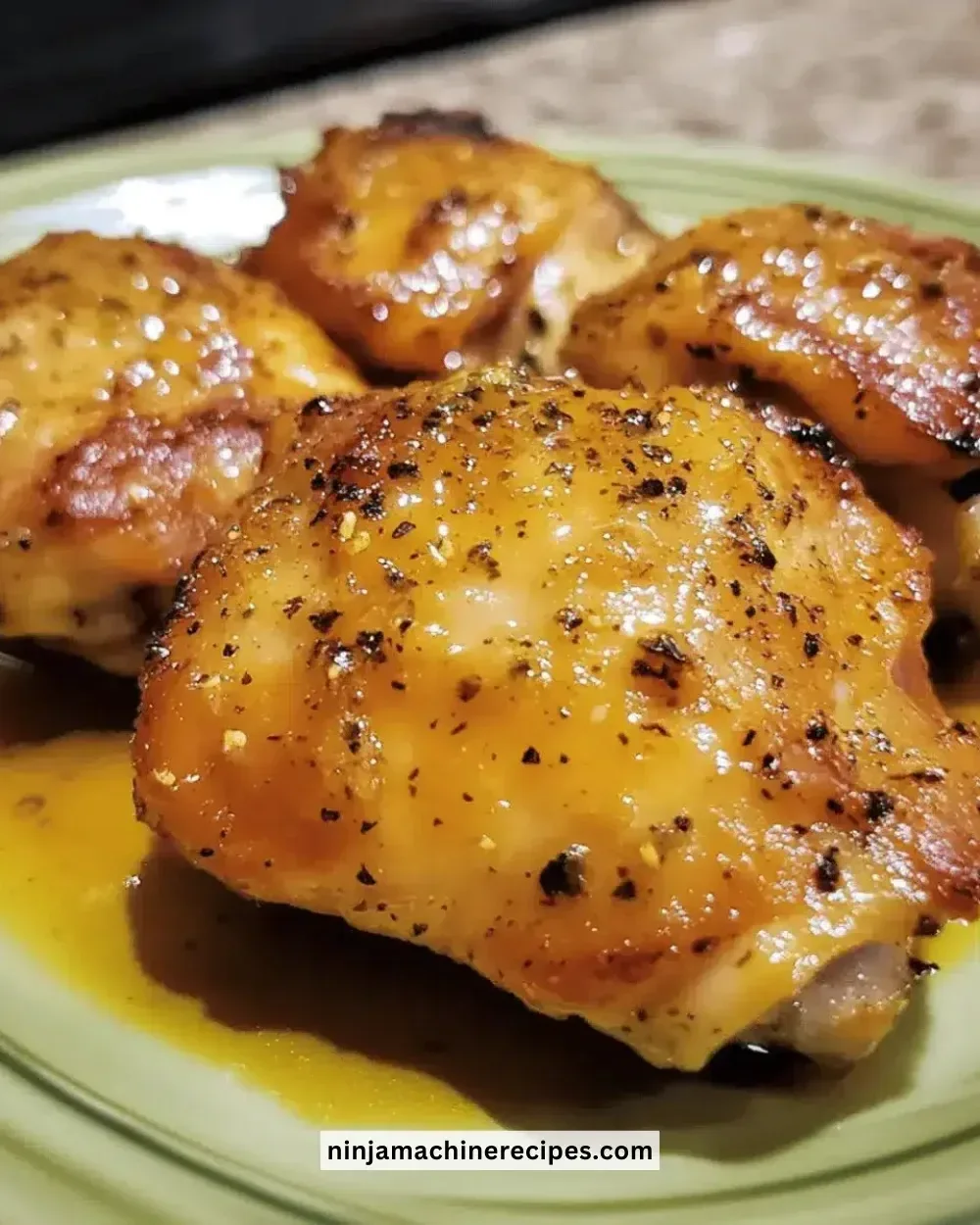 Juicy honey mustard chicken thighs with herbs and spices on a plate