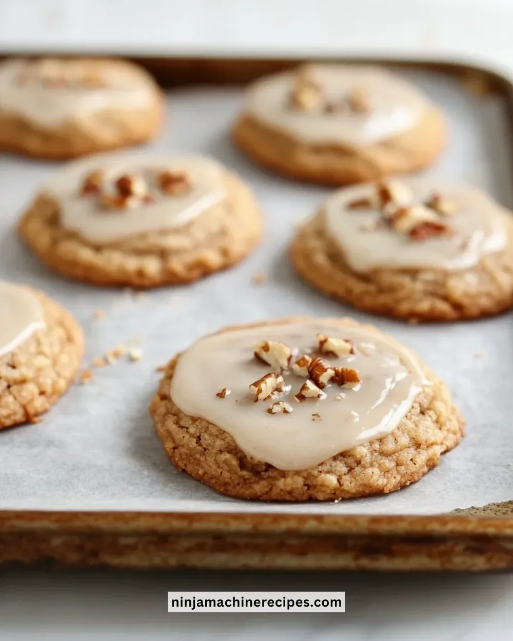 Plate of freshly baked Maple Brown Sugar Cookies with a drizzle of maple syrup.