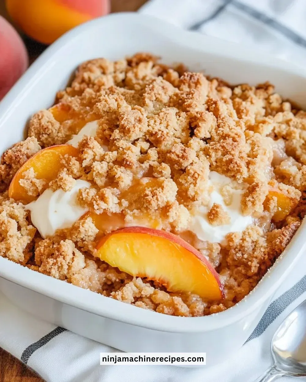 Homemade Peach Crisp dessert with a golden crumble topping and fresh peaches.