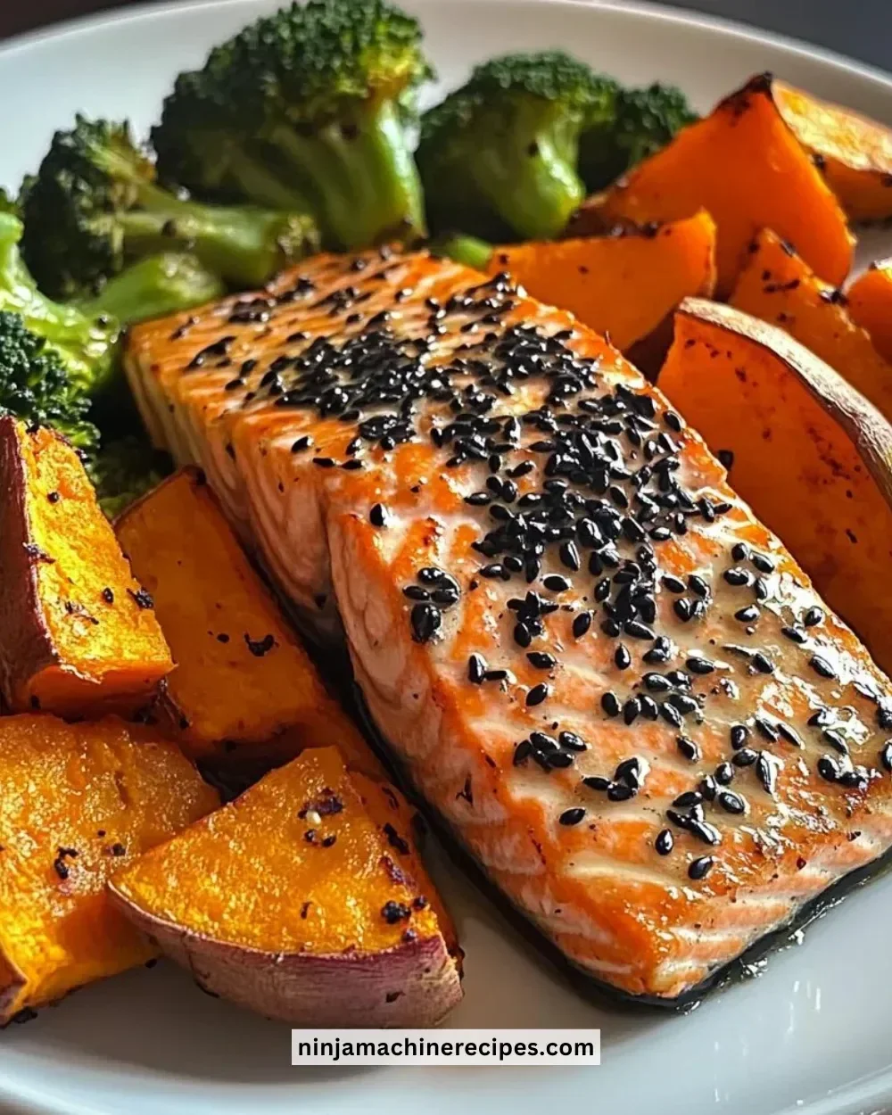 Sesame glazed salmon with sweet potato wedges and broccoli on a plate