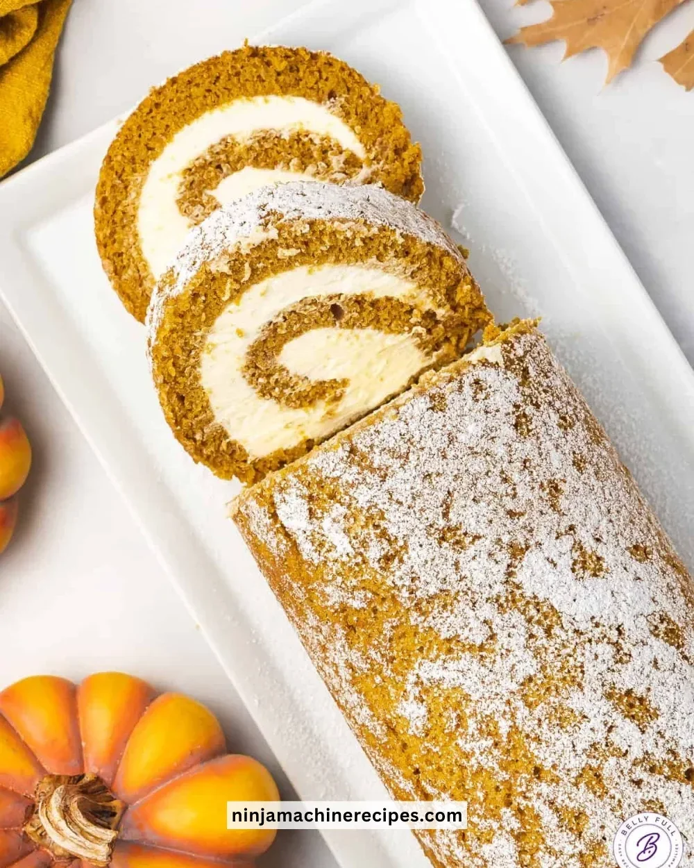 Delicious homemade pumpkin roll with cream cheese filling on a wooden table