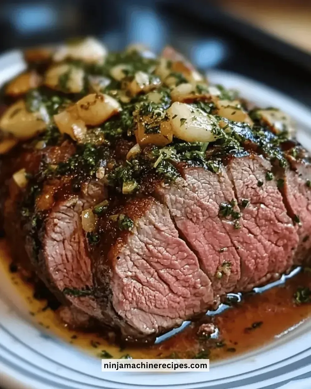 Delicious herb butter roast served on a platter with herbs and spices.