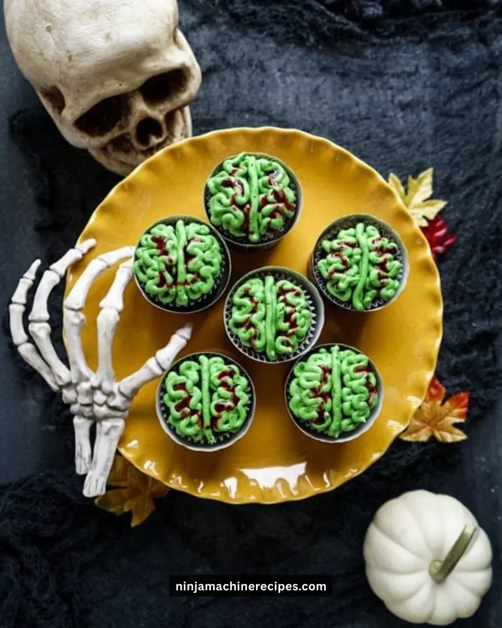 Halloween zombie brain cupcakes topped with spooky designs and colorful icing.