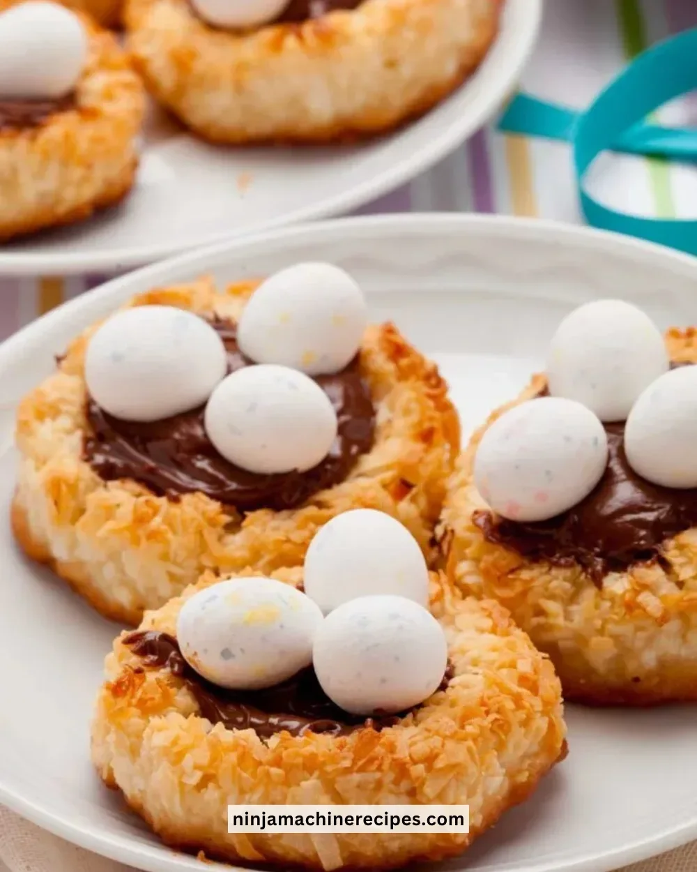 Plate of homemade Birds Nest Cookies decorated with chocolate and candy eggs.