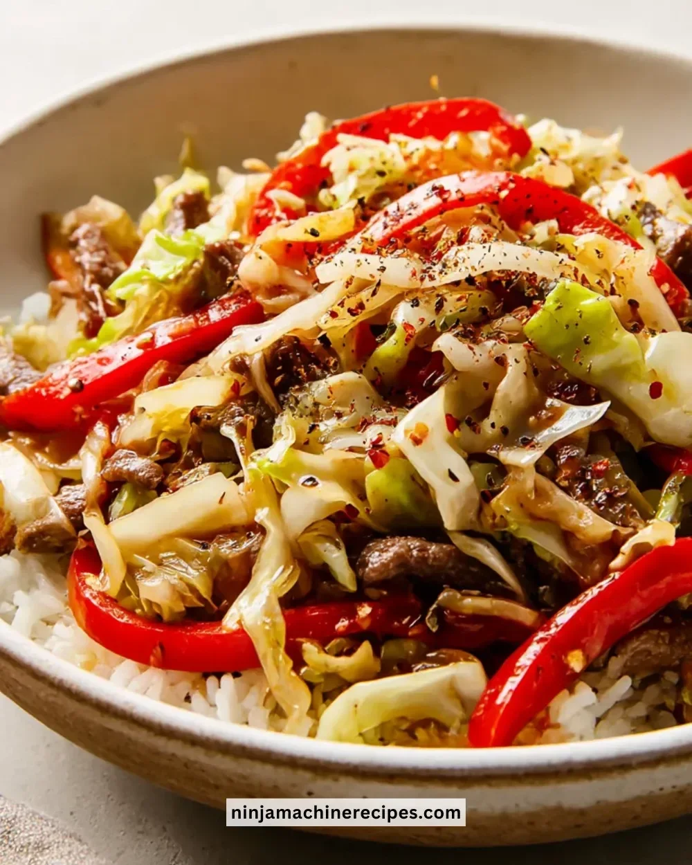 Delicious black pepper beef and cabbage stir-fry served in a bowl.
