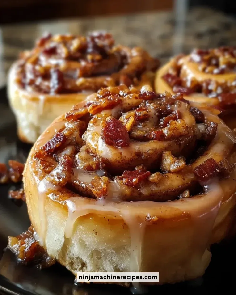 Delicious Bourbon Maple Bacon Cinnamon Rolls topped with maple glaze.