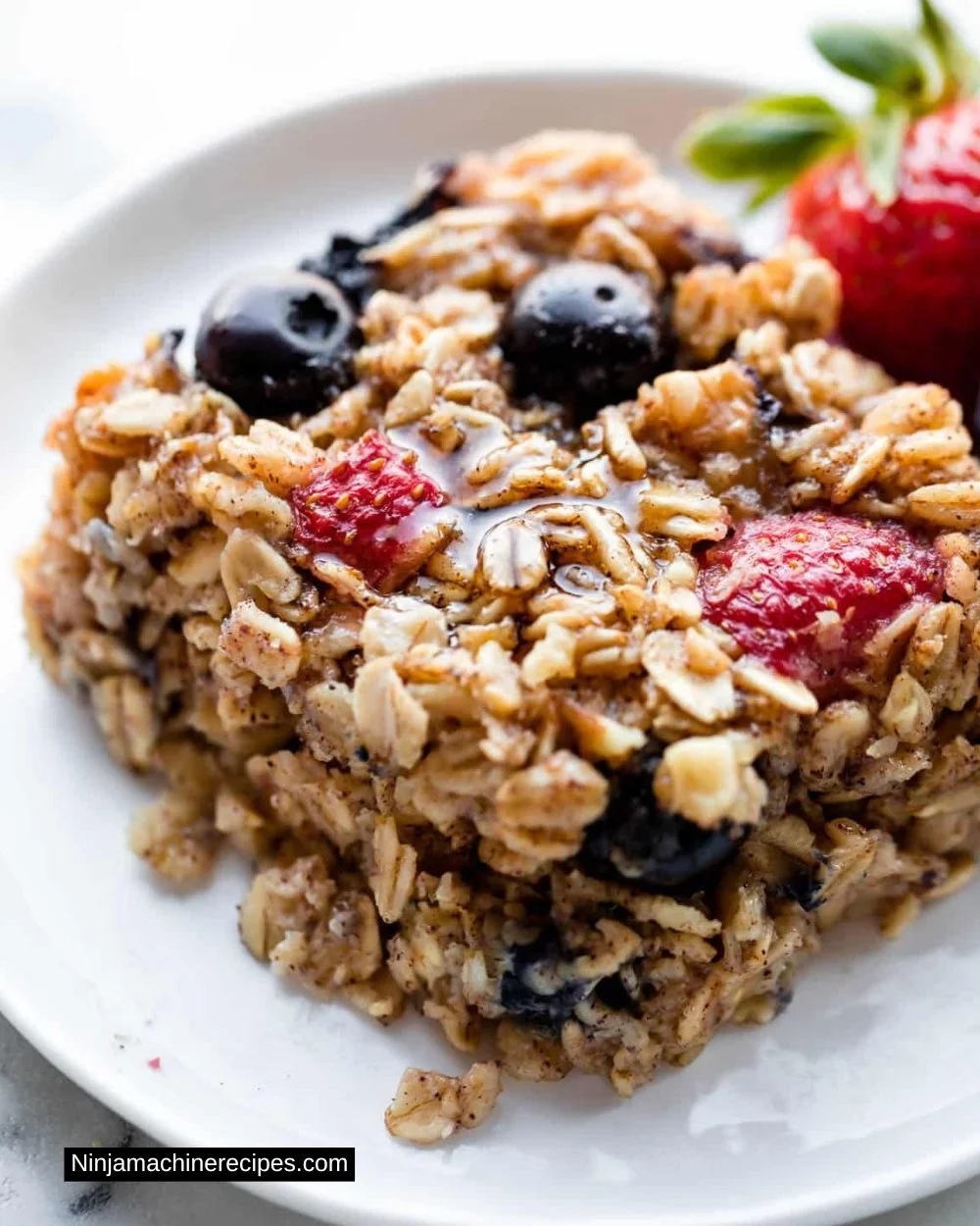 Delicious bowl baked oatmeal topped with fresh fruits and nuts.