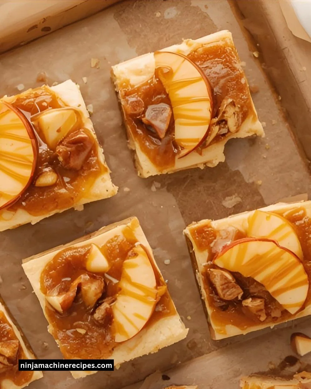 Delicious caramel apple cheesecake bars topped with caramel drizzles and apple slices