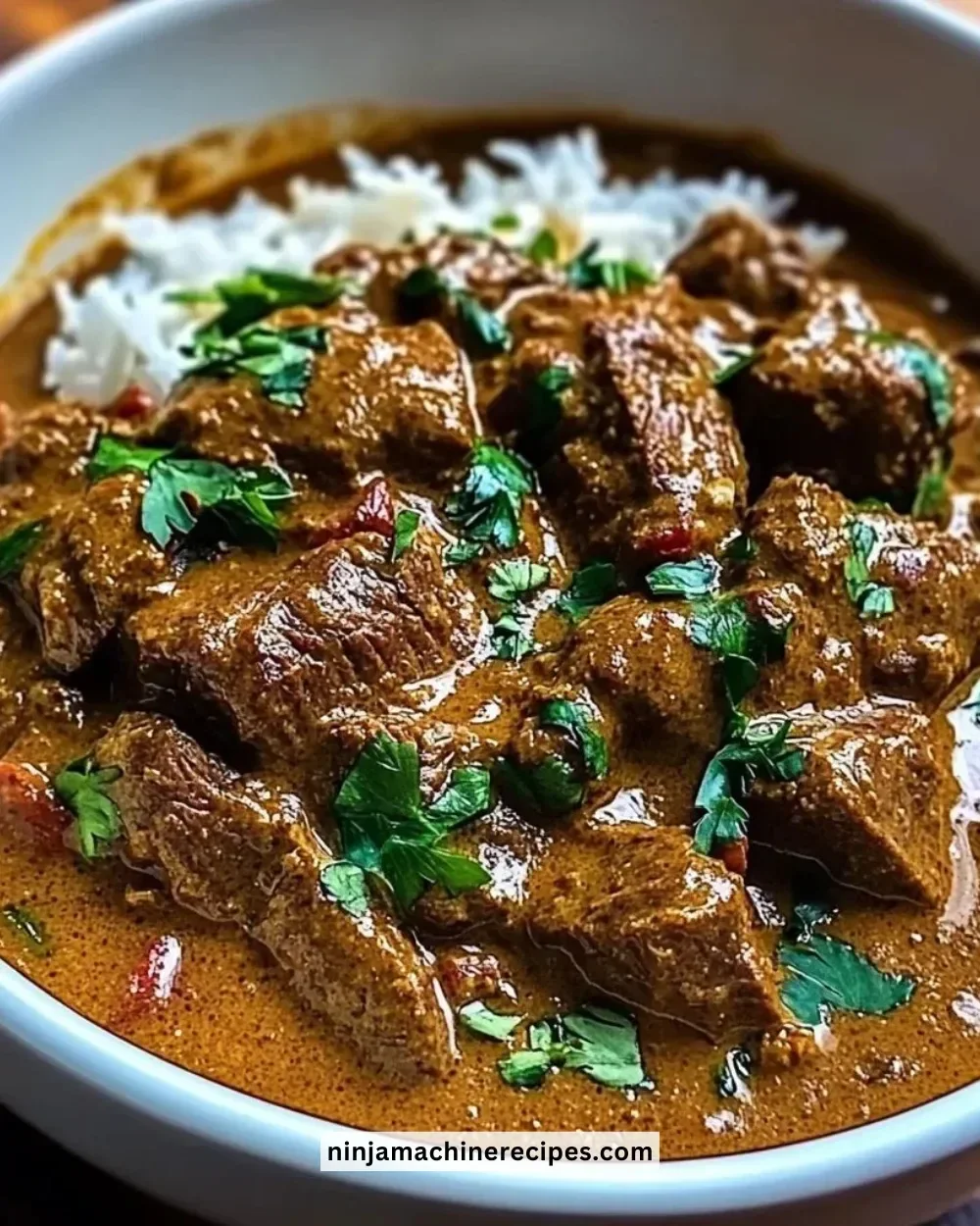 Delicious coconut-infused beef curry served in a bowl with fresh herbs.