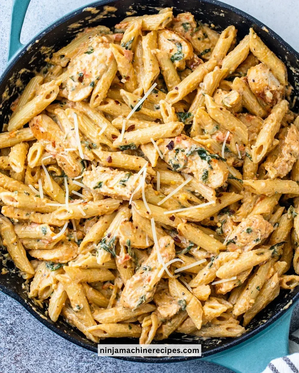 Creamy garlic chicken pasta dish with fresh herbs and garlic sauce.