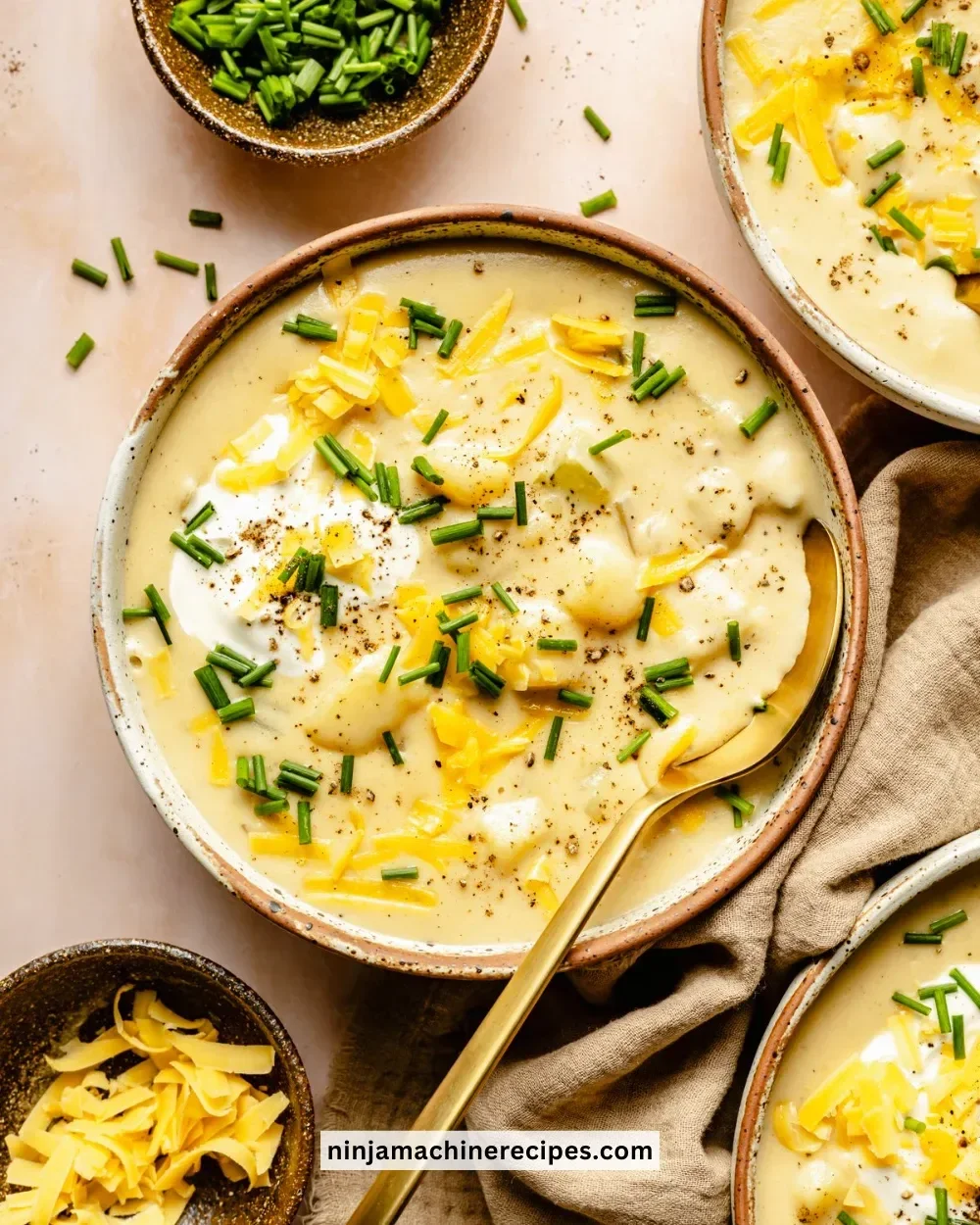 Delicious creamy potato soup in a bowl, topped with herbs and served hot.