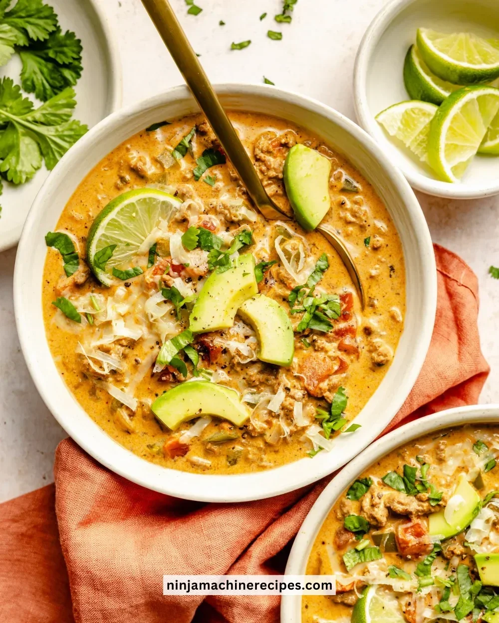 Bowl of creamy taco soup topped with cheese and fresh cilantro