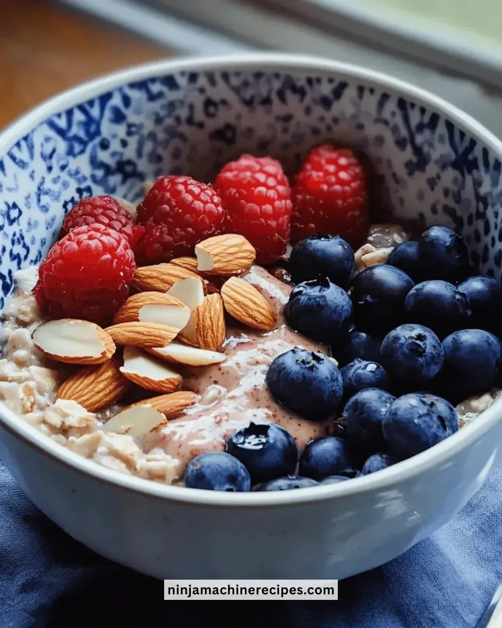 Delicious berry almond oatmeal bowl topped with fresh fruits and nuts