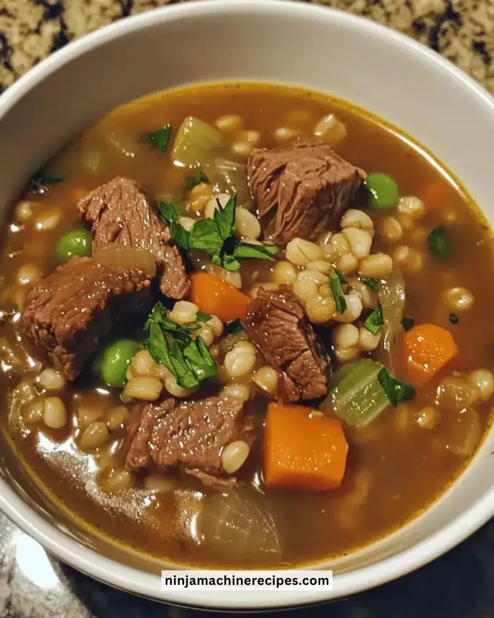 Bowl of easy cozy beef barley soup filled with vegetables and tender beef