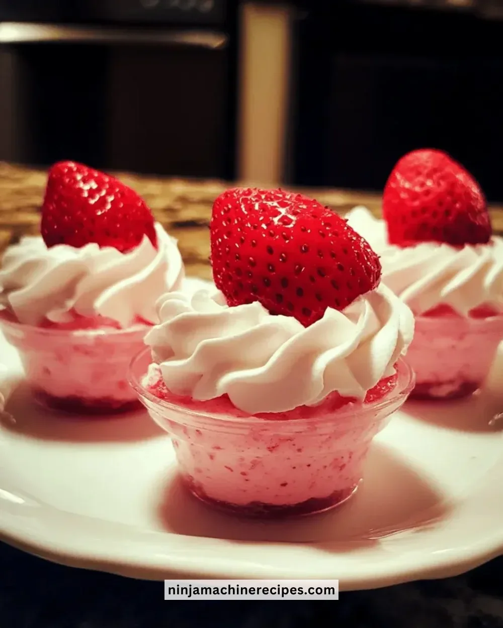 Easy fluffy strawberry mousse cups topped with fresh strawberries