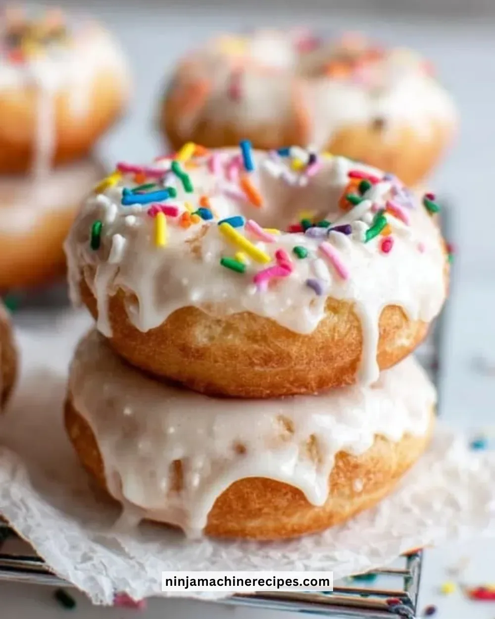 Delicious easy vegan donuts topped with colorful sprinkles on a plate.
