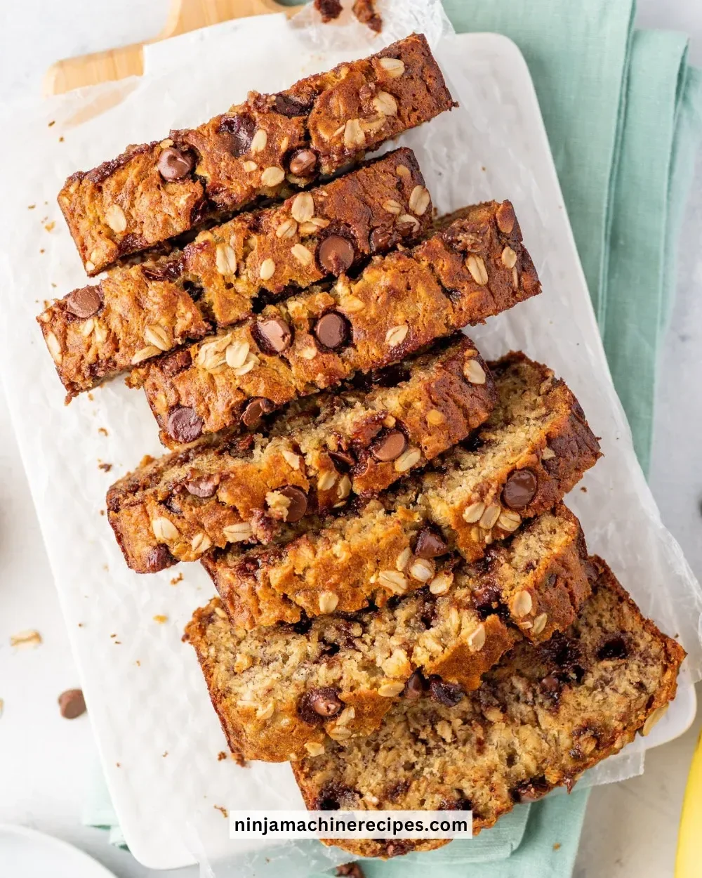 Sliced healthy oatmeal banana bread on a wooden table