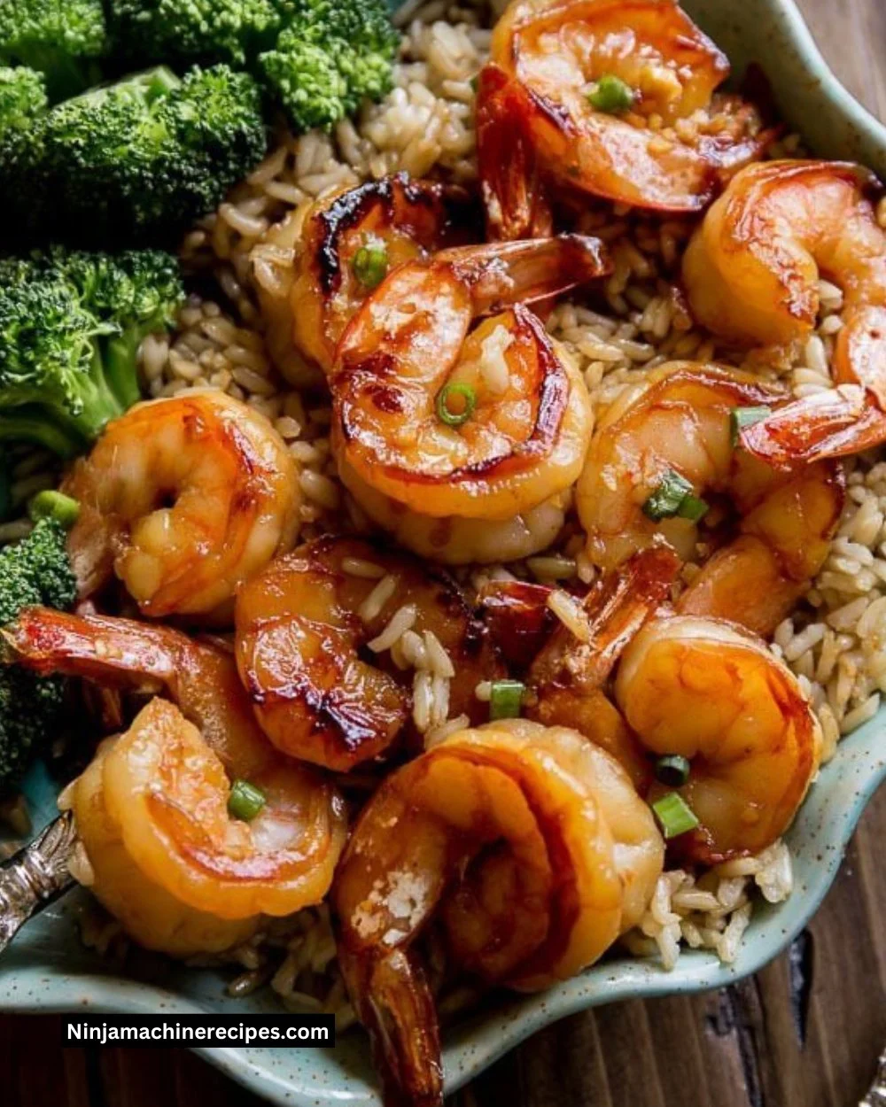 Plate of honey garlic shrimp garnished with green onions and sesame seeds.