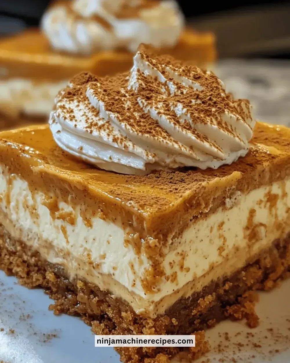Irresistible pumpkin spice cheesecake bars served on a plate