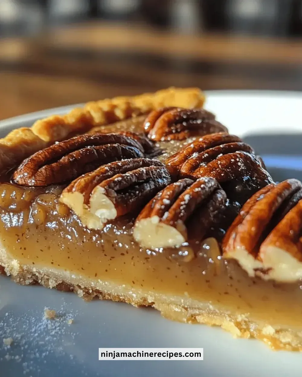 Irresistible salted caramel pecan tart topped with caramel drizzle and pecans.