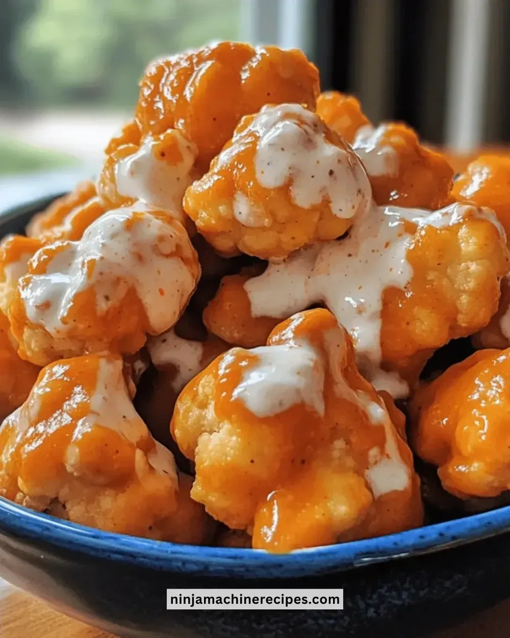 Delicious Buffalo Cauliflower Bites served in a bowl with creamy sauce