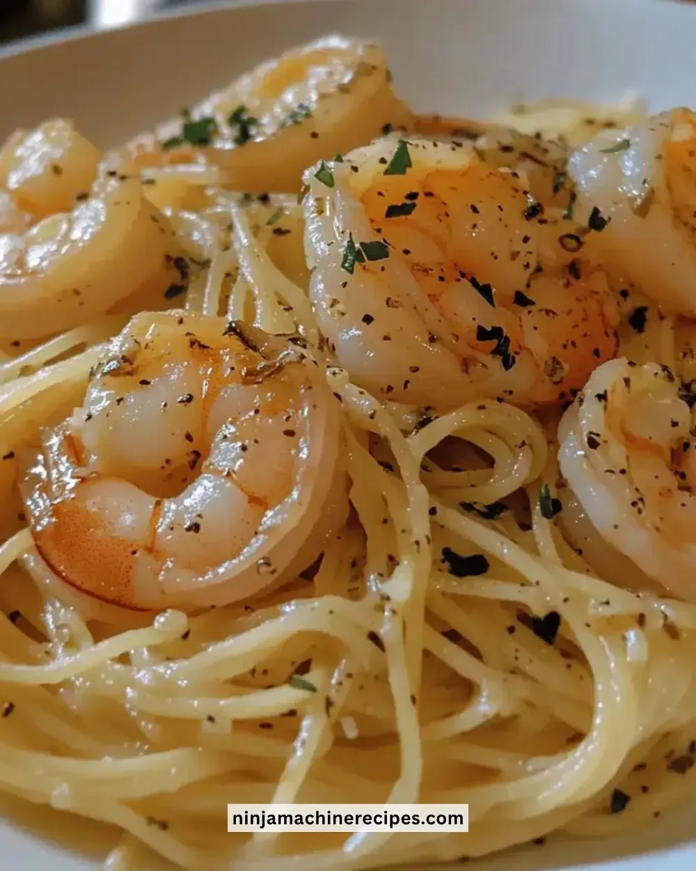 Delicious garlic butter shrimp pasta garnished with parsley and lemon