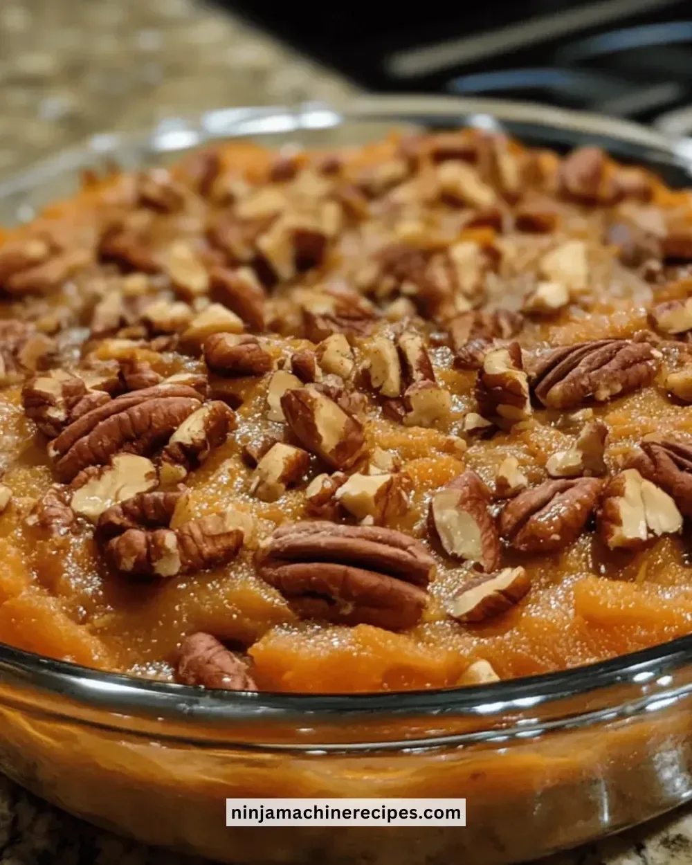 Delicious sweet potato casserole topped with pecans, ready for serving.