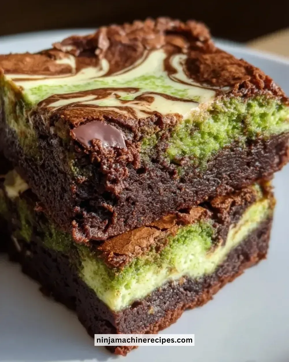Delicious Matcha Cheesecake Swirl Brownies with a green matcha topping