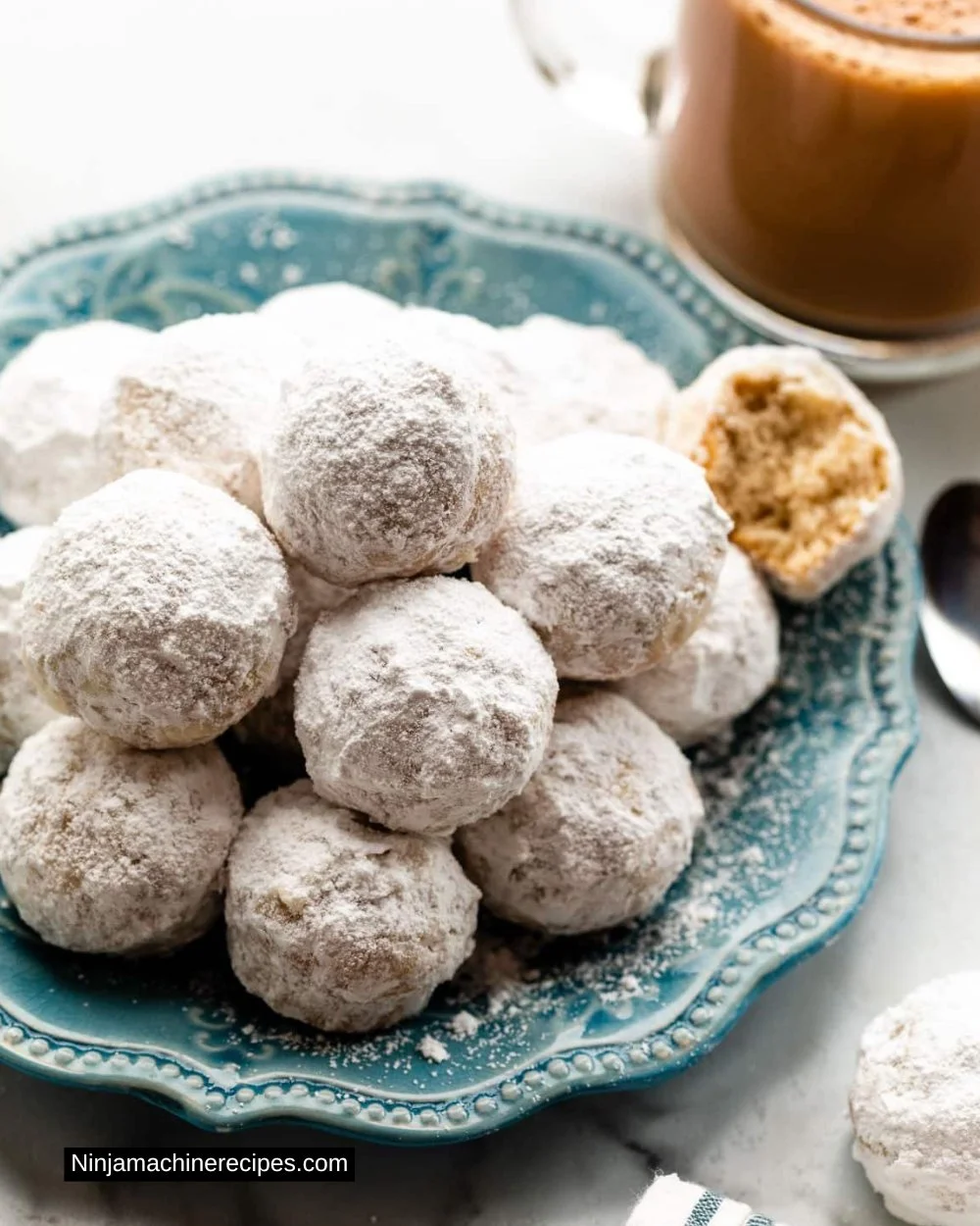 Mini powdered sugar donut muffins freshly baked on a cooling rack.