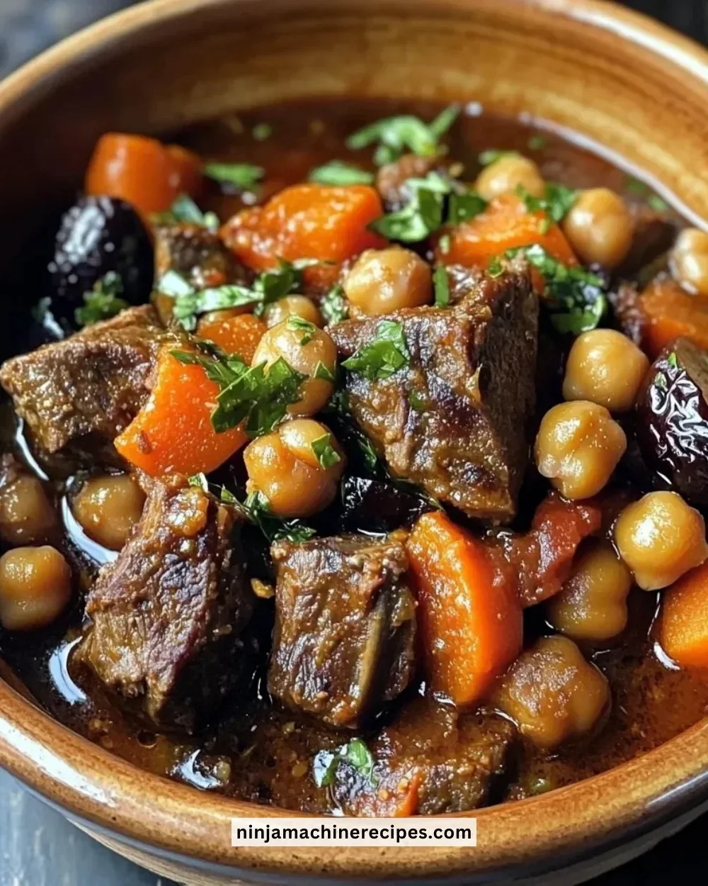 Delicious Moroccan Lamb Tagine with prunes and chickpeas served in a traditional pot.