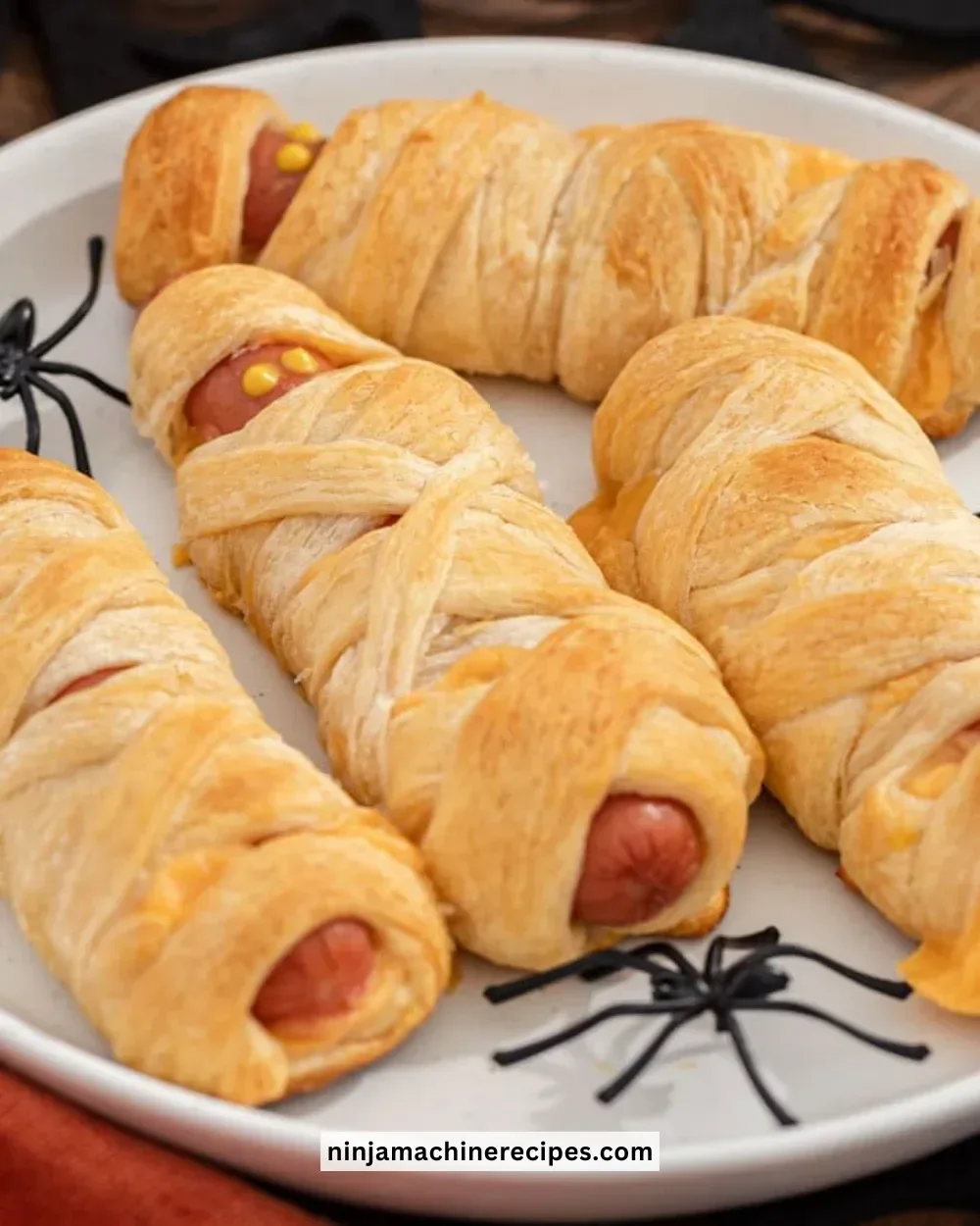 Baked Mummy Hot Dogs wrapped in crescent rolls for Halloween treats